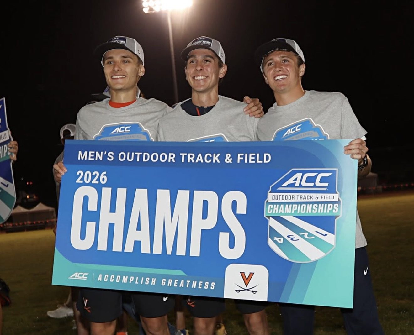 Virginia teammates holding the ACC outdoor track and field championship banner