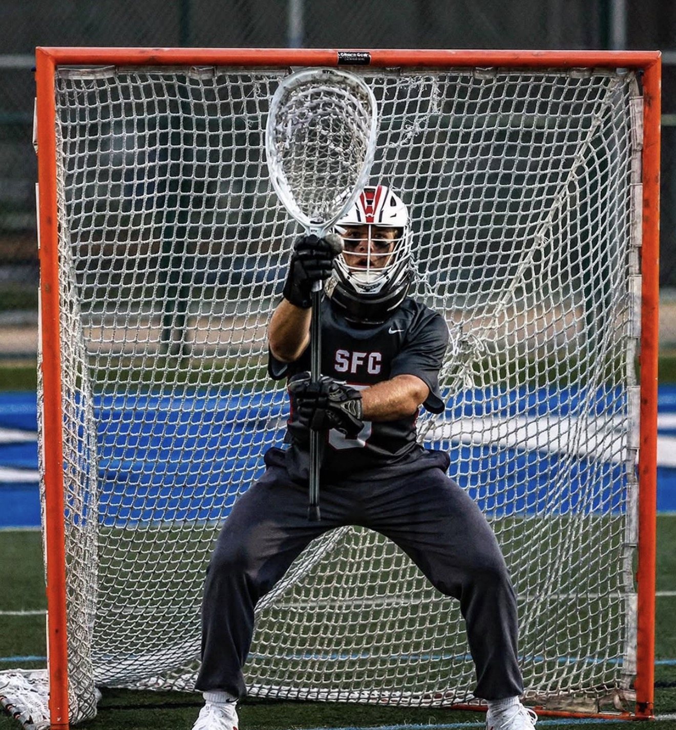 Goalie in a ready stance in front of the net